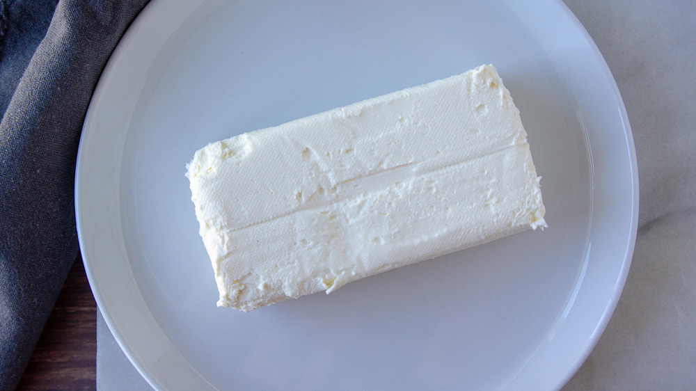 a block of cream cheese on a white plate