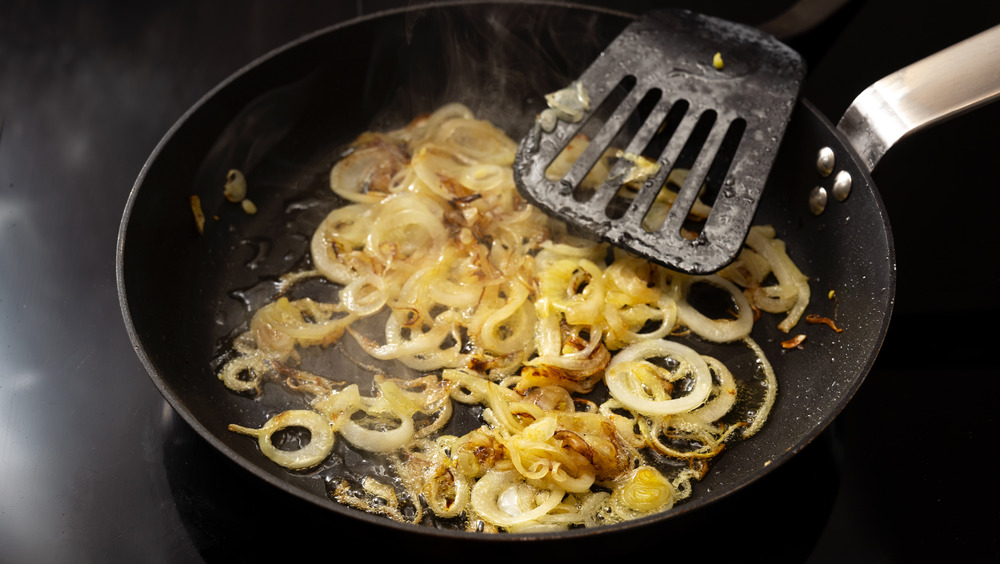 Onions frying in a black cast iron frying pan