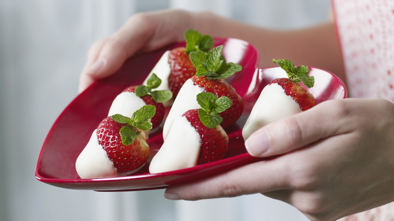 White chocolate-covered strawberries on plate