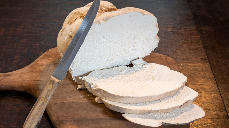 person slicing a puffball mushroom