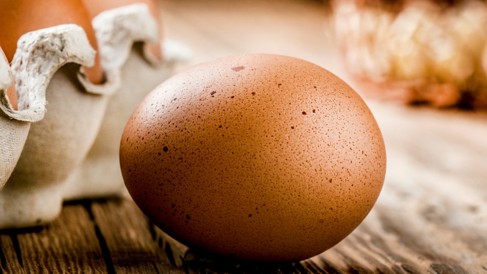 speckled brown egg on a wooden table