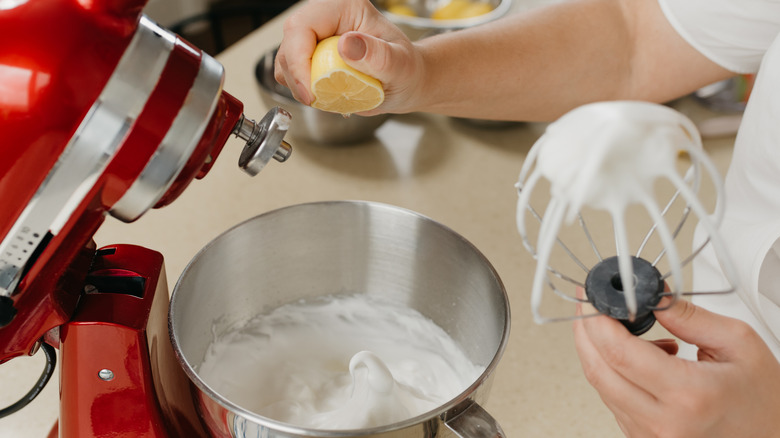 Squeezing lemon juice into meringue