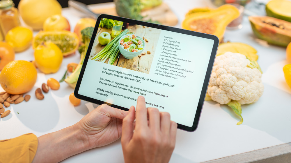 Woman reading recipe on tablet