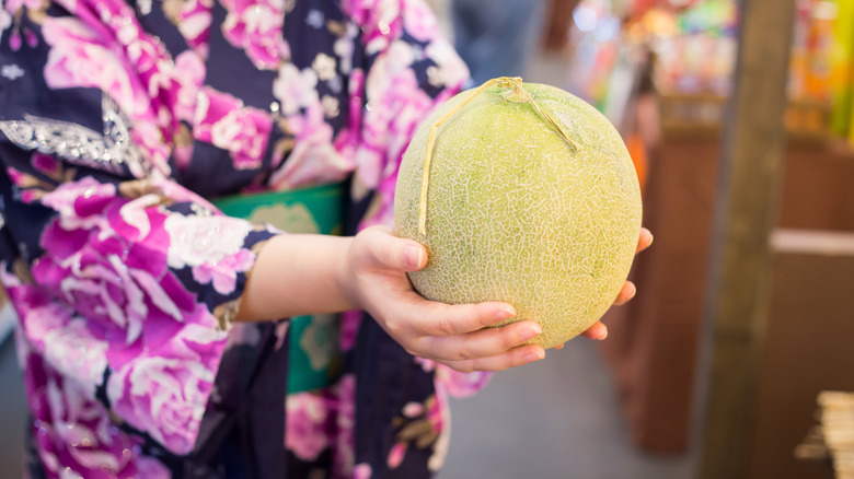 Woman holding a cantaloupe