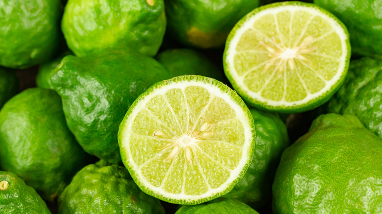 fresh limes, one sliced in half