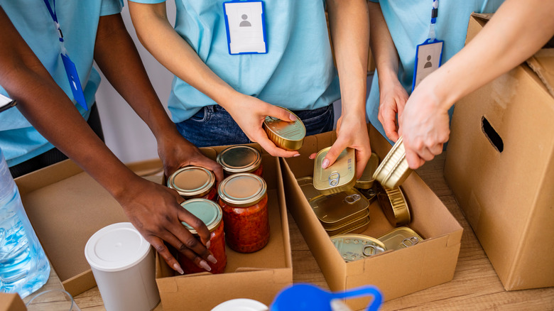 Volunteers packing canned goods