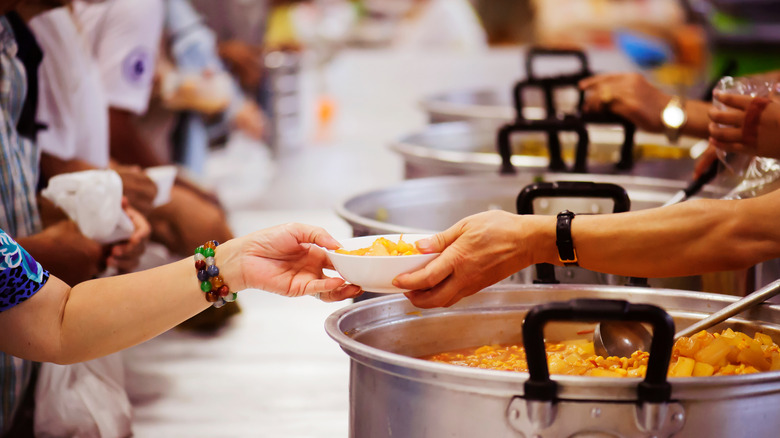 serving food at soup kitchen