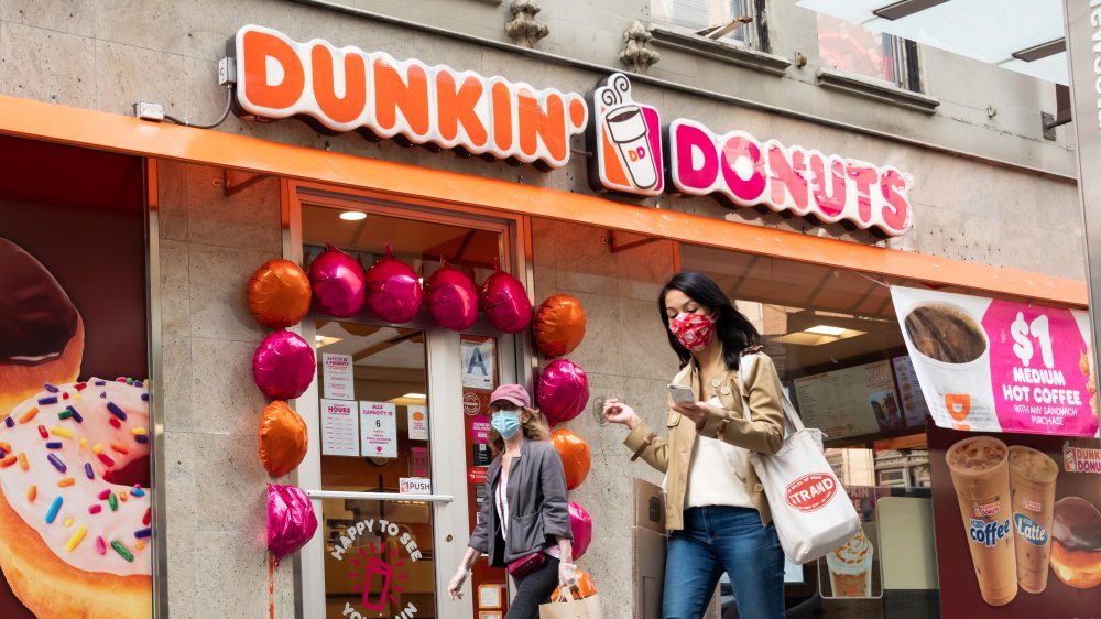 women walking by Dunkin'