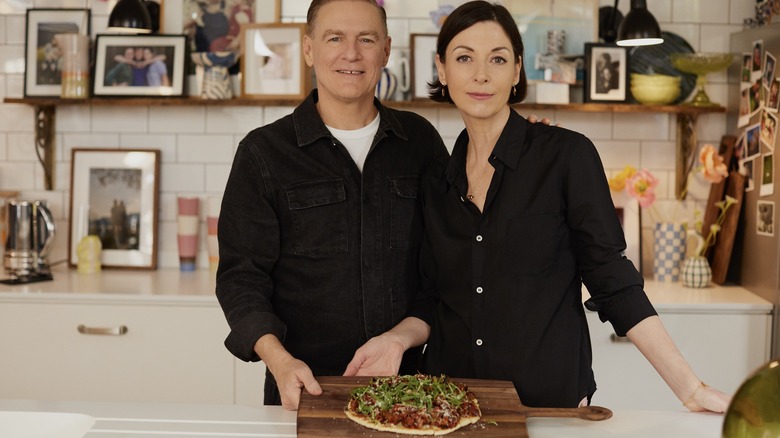 Bryan Adams and Mary McCartney with a pizza