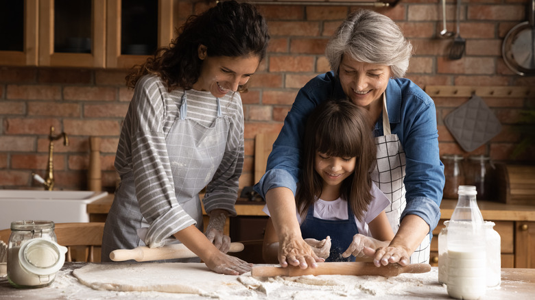 three generations of women cooking together