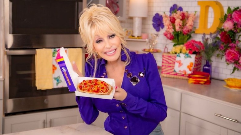 Dolly Parton holding Taco Bell Mexican Pizza