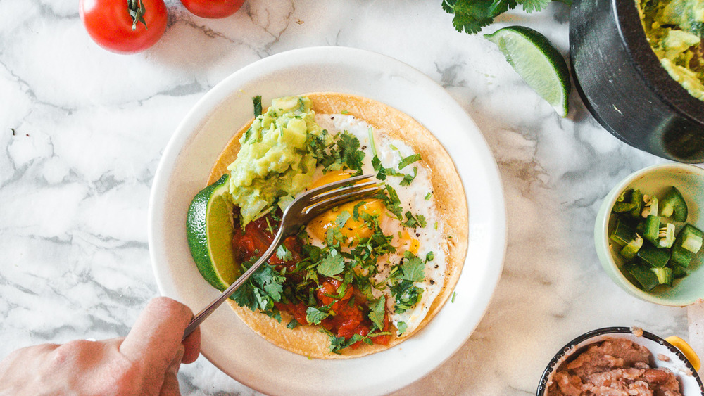 breaking yolk on huevos rancheros