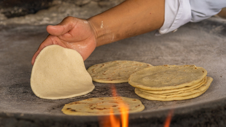 hand cooking corn tortillas 