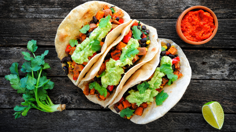 Colorful tacos with lime and salsa