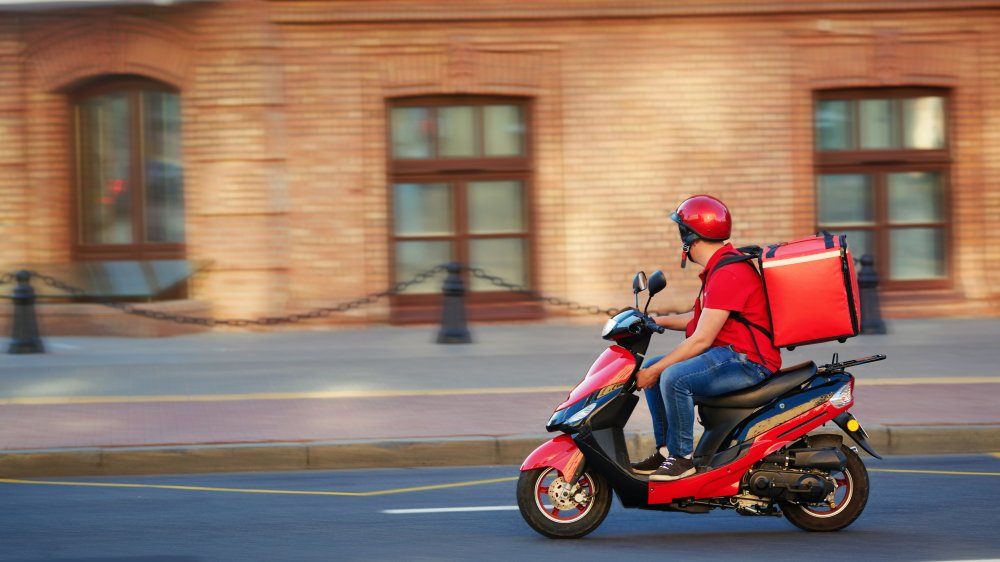 Delivery driver carrying orders