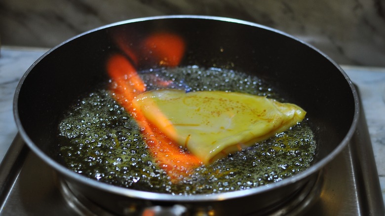 Crêpes Suzette aflame in a pan 