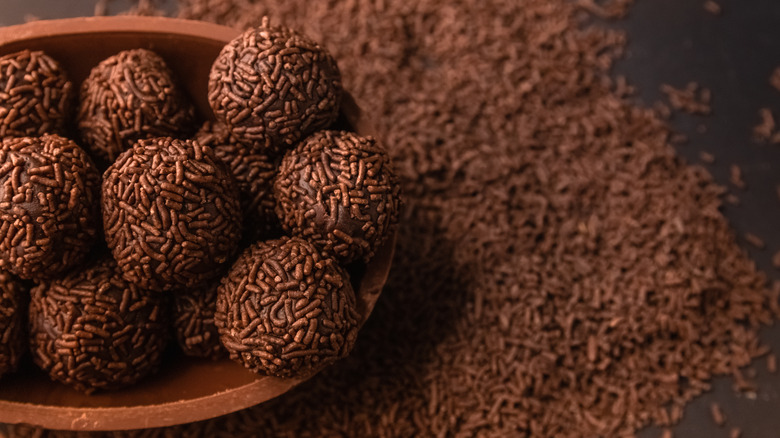 Bowl of brigadeiros against a pile of sprinkles