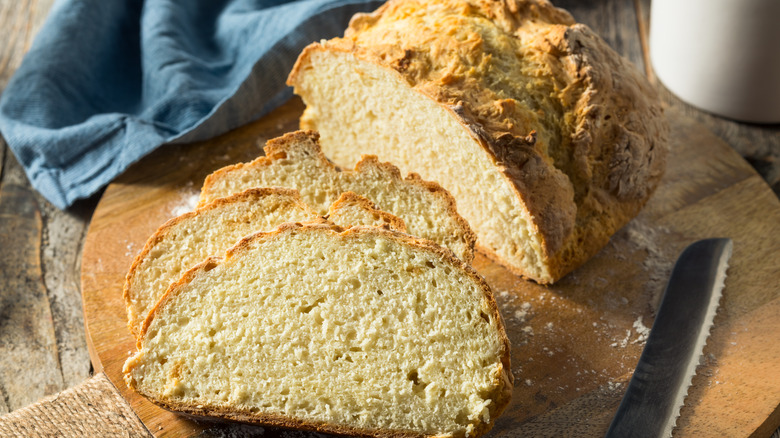 Irish soda bread sliced on wooden cutting board