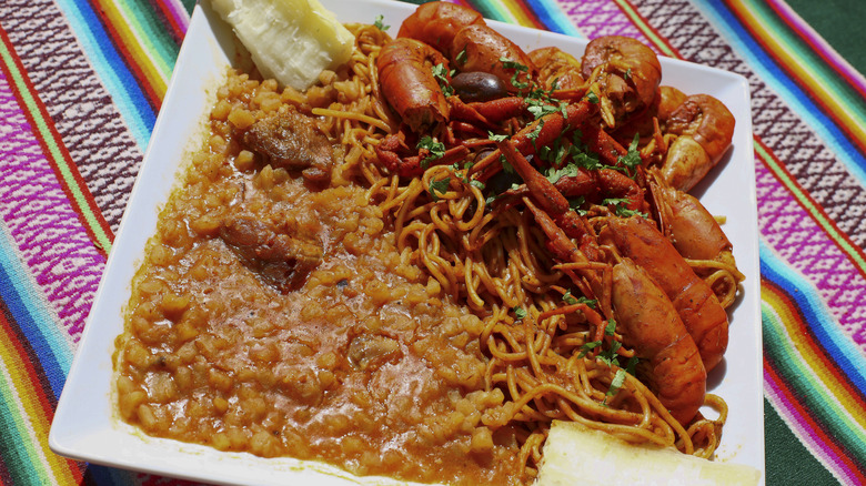 Peruvian pork stew with noodles and prawns