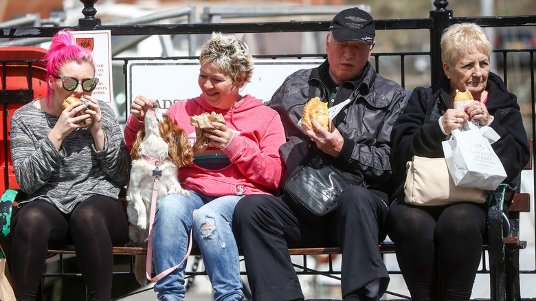 People eating Cornish pasties