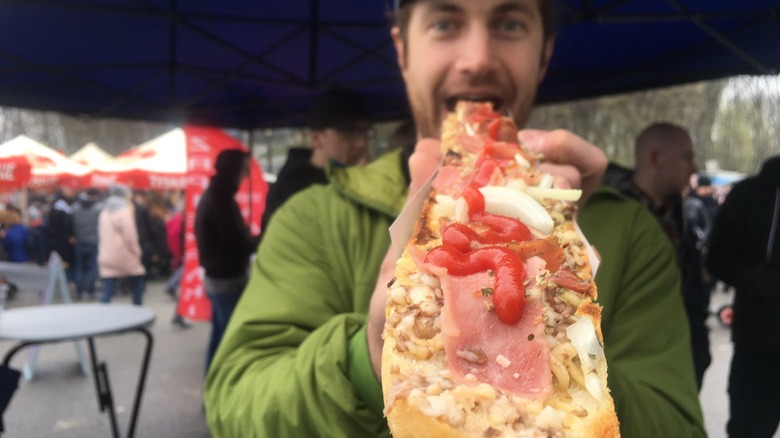 Man eating zapiekanka