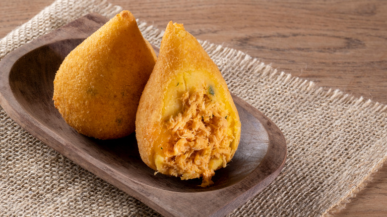 Two coxinhas, one sliced open