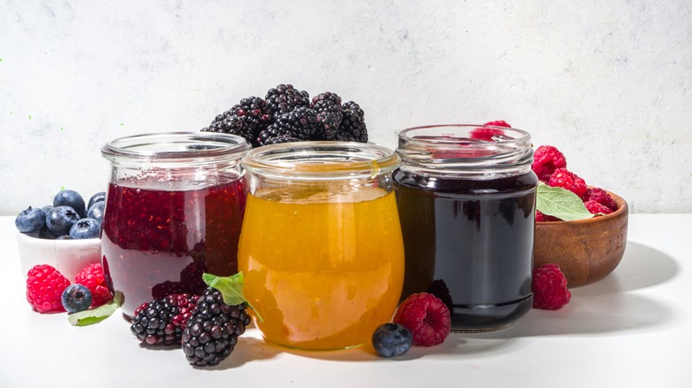 Trio of jam in jars with fruit