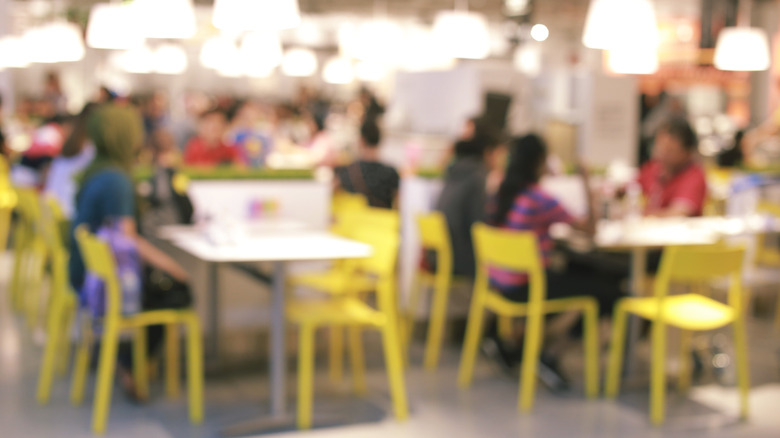 out of focus people eating at ikea-style cafeteria