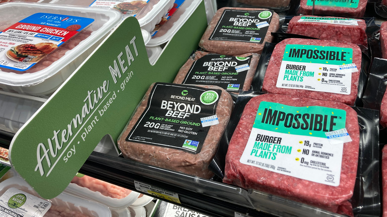 Impossible Foods Burger and Beyond Meat Beyond Beef in the cooler at a supermarket