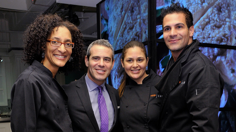 Carla Hall and Andy Cohen smiling at a Bravo event