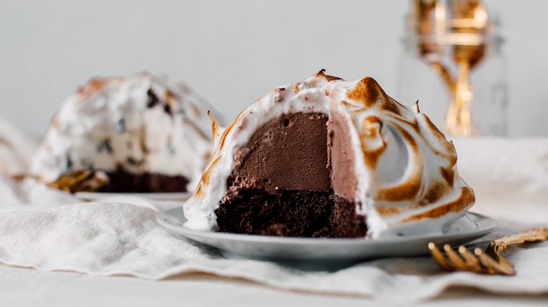 Sliced baked Alaska dessert on plate