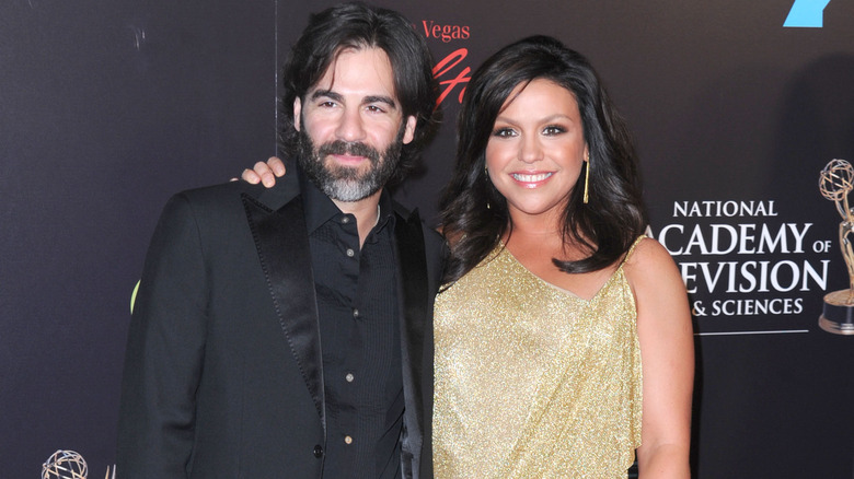 John Cusimano smiles with Rachael Ray in gold dress