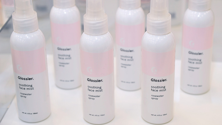 Bottles of Glossier rosewater spray