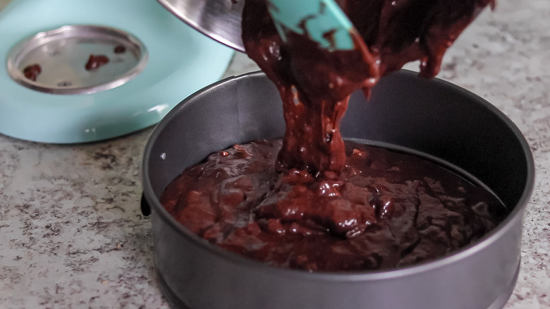 pouring chocolate batter into pan