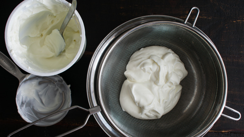 Sieve with yogurt draining into a pot