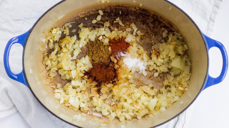 Diced Onions and spices in pot dutch oven