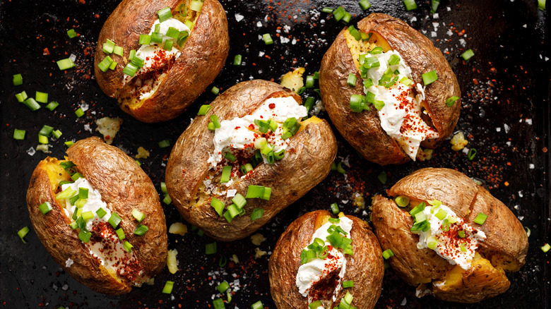 Baked potatoes topped with sour cream and chives