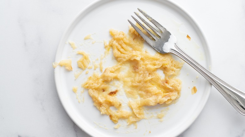 mashed cloves of garlic on white plate