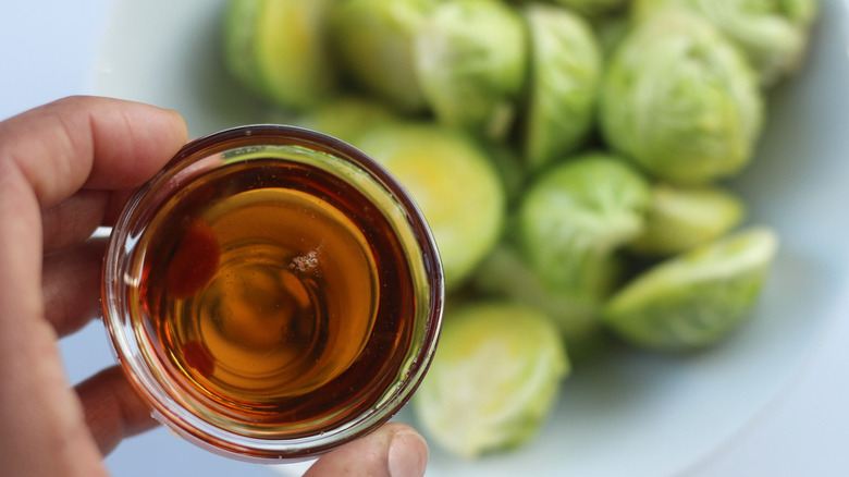 syrup being added to sprouts