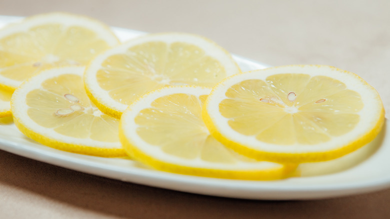 Thinly sliced lemon on a white dish