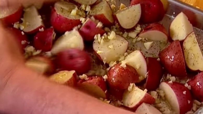 Tossing potatoes, olive oil and garlic