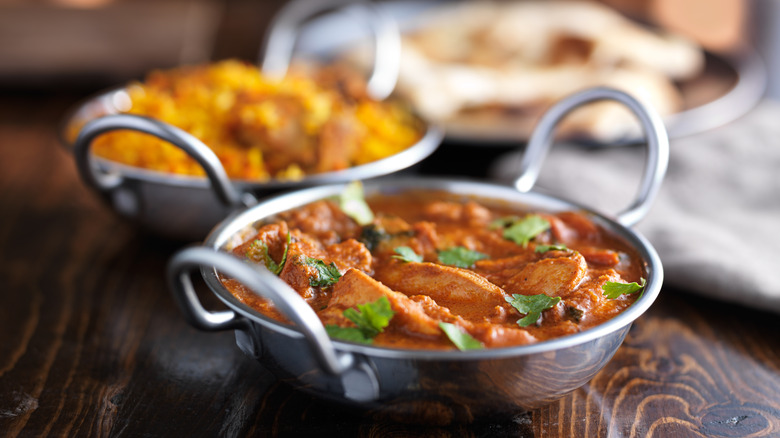 Two pans with balti curries