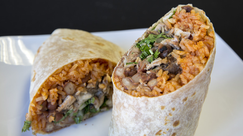 Burrito with rice, beans, chicken, and cilantro