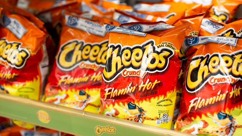 bags of cheetos on shelf in grocery store