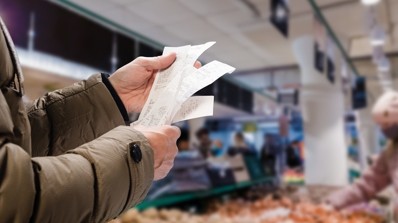 man holding receipts