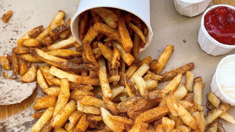 fries spilling out of paper cup