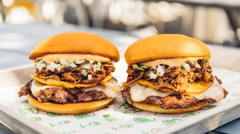 two burgers on metal tray