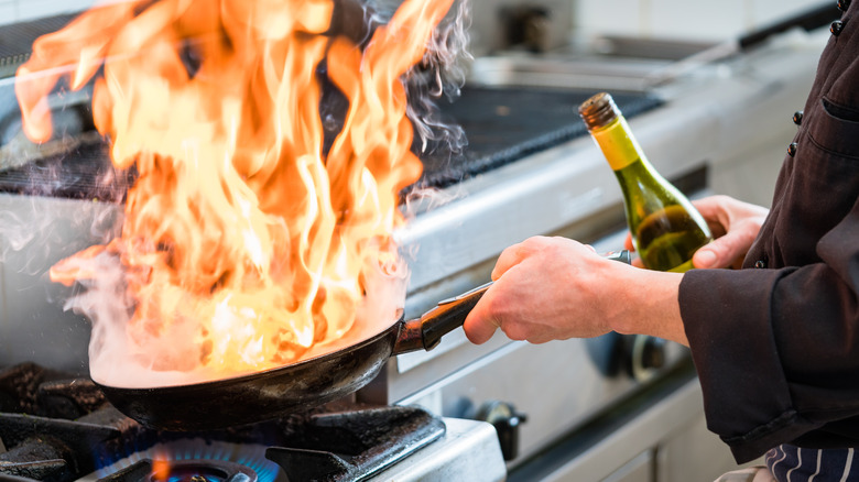 Flambe pan with alcohol bottle