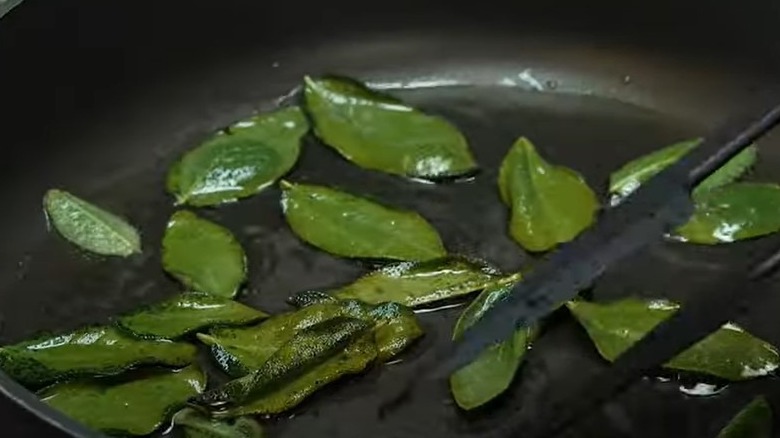 Sage leaves frying in a pan