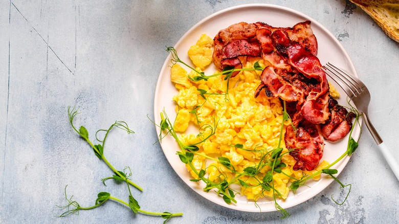 Plate of scrambled eggs and bacon